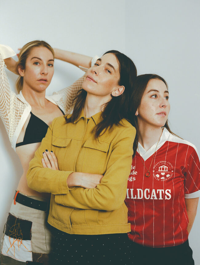 左はヴォーカル、ベースを担当する長女のエスティ・ハイム。中央はリードヴォーカル、リードギター、ドラムのほか、楽曲のプロデュースも手がける次女のダニエル・ハイム。右はヴォーカル、リズムギター、キーボード、パーカッションをマルチに担当する三女のアラナ・ハイム。