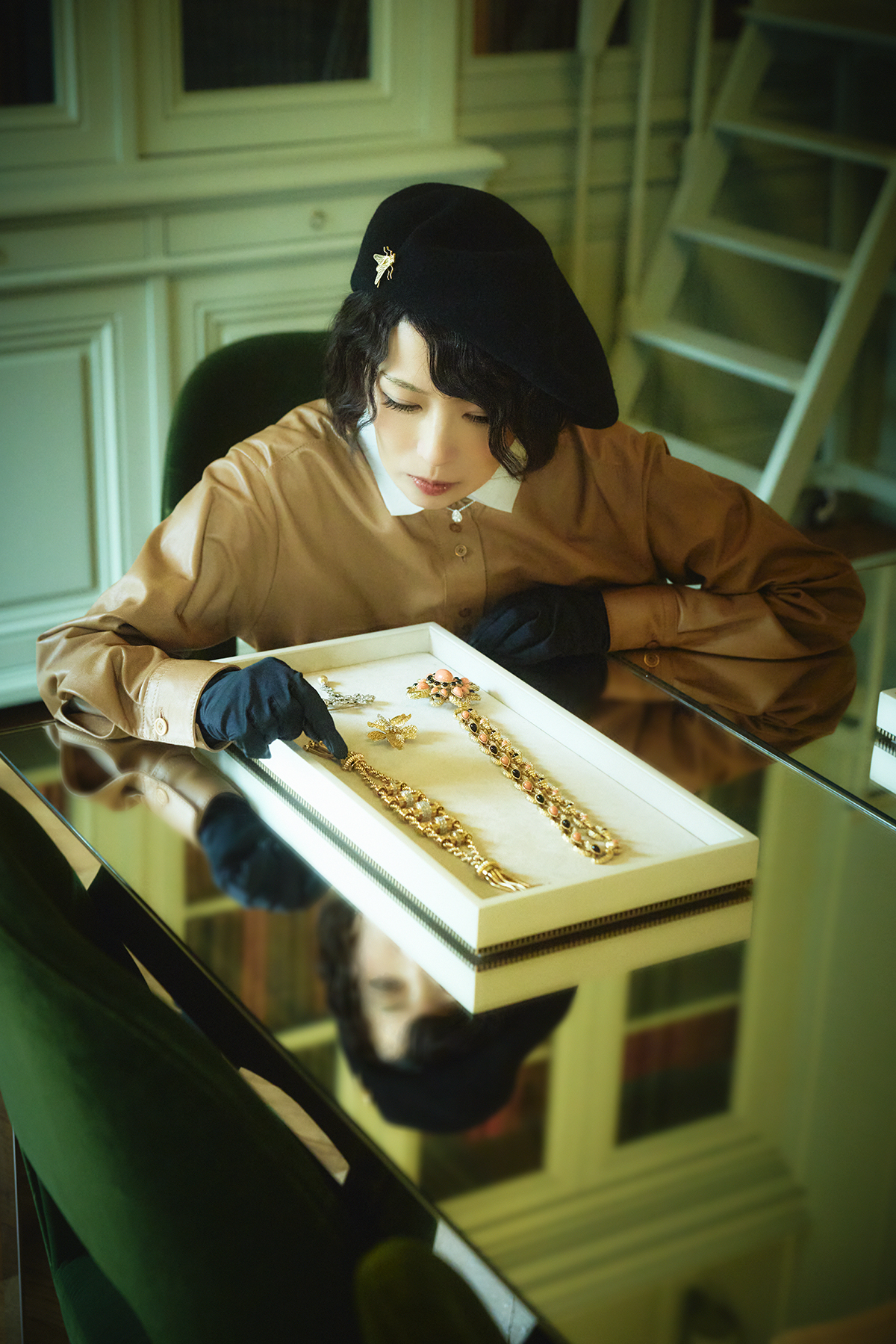 帽子につけたブローチ Fly brooch(イエローゴールド) 1946年 トレイのなか右ネックレス Serpent long necklace(イエローゴールド、コーラル、オニキス)1974年 トレイのなか中奥ブローチ Chestnut brooch (イエローゴールド、プラチナ、パール、ダイヤモンド)1906年頃 トレイのなか中手前ブローチ Azalea clip brooch(イエローゴールド、プラチナ、ダイヤモンド)1959年 トレイのなか左ブレスレットTassel bracelet(イエローゴールド、プラチナ、ダイヤモンド)1946年/すべてブシュロン プライベート コレクション